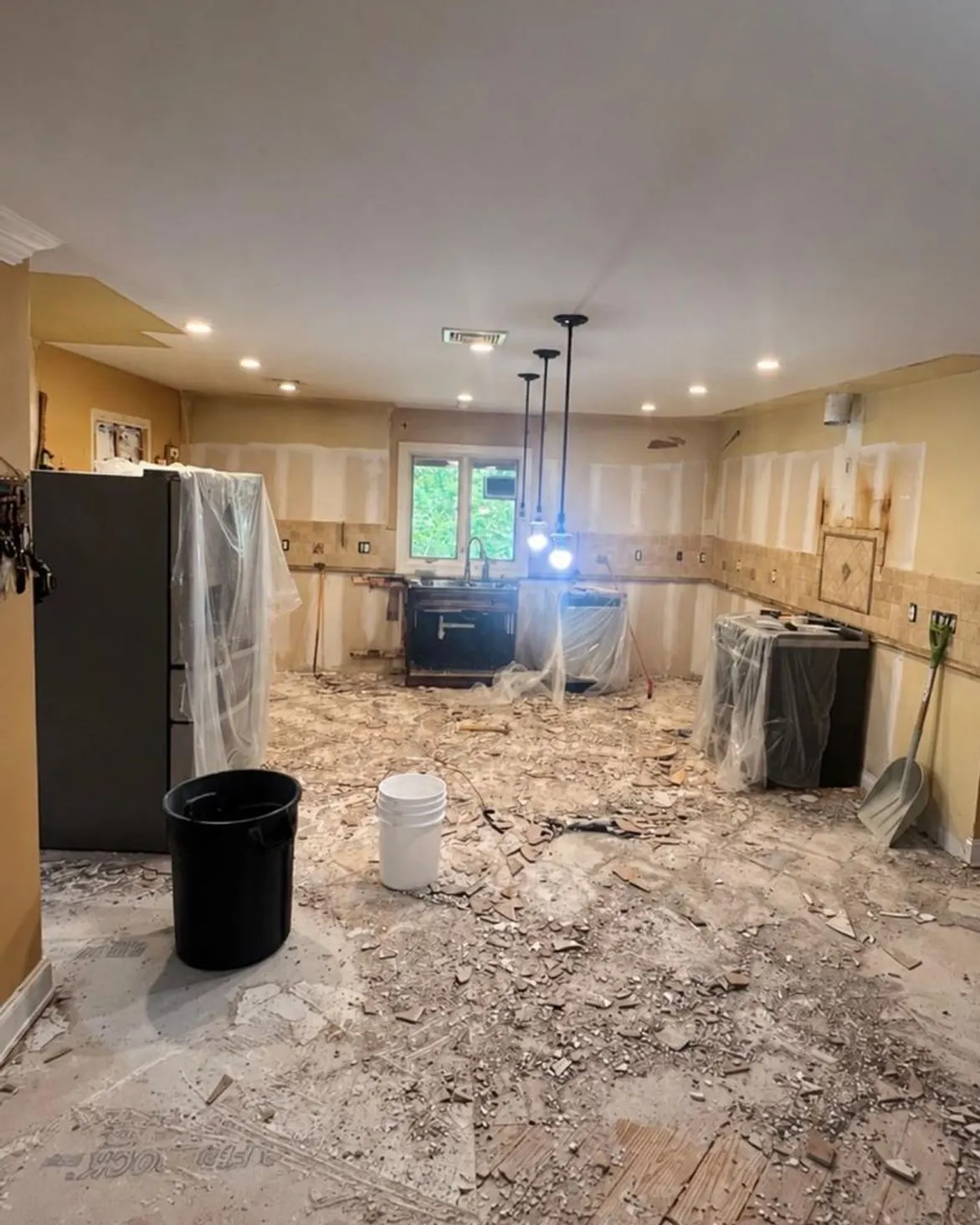 Clifton, NJ kitchen gutted during demolition, with the old tile floor torn up