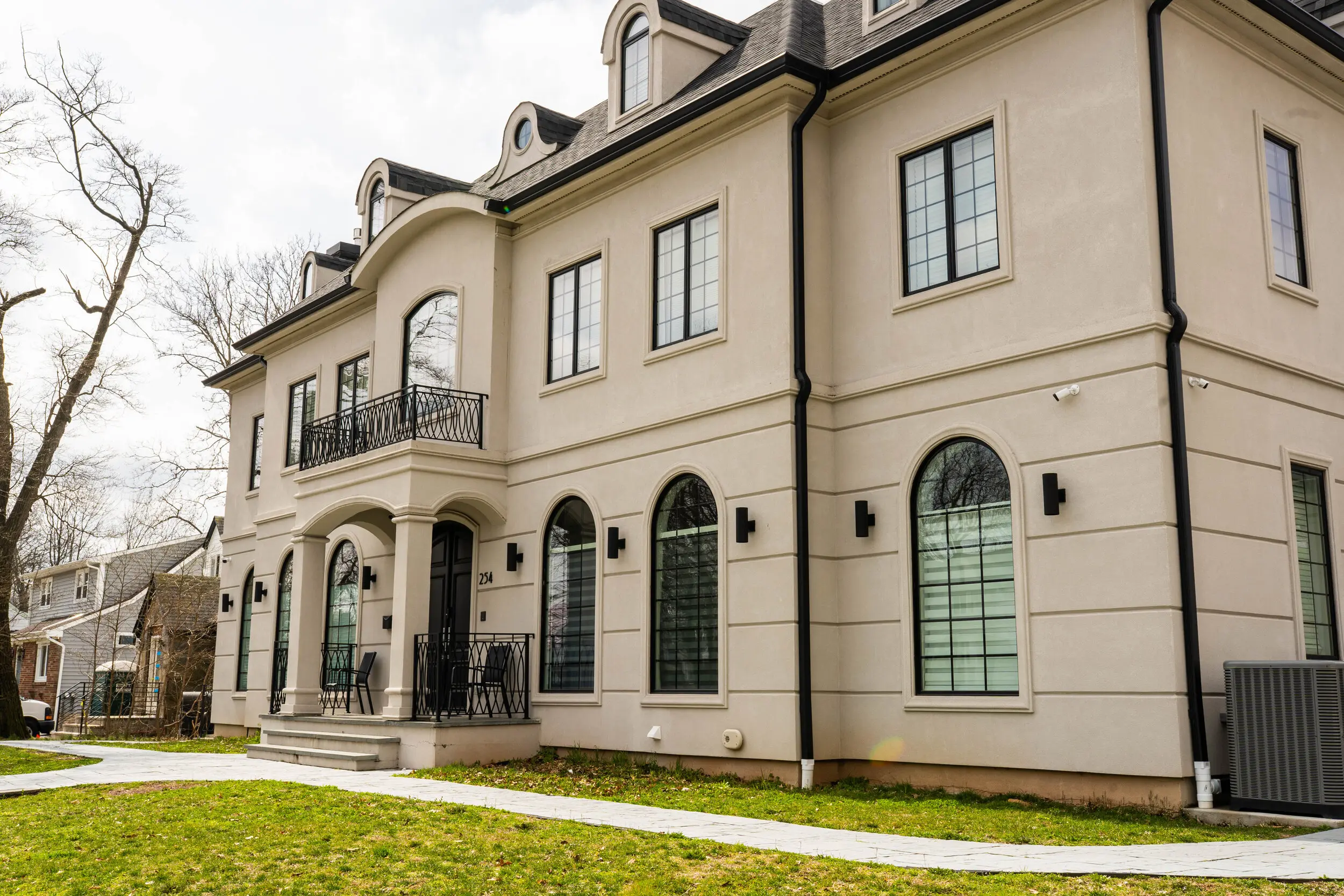Custom home with arched windows and a front balcony built by Omar Construction in New Jersey
