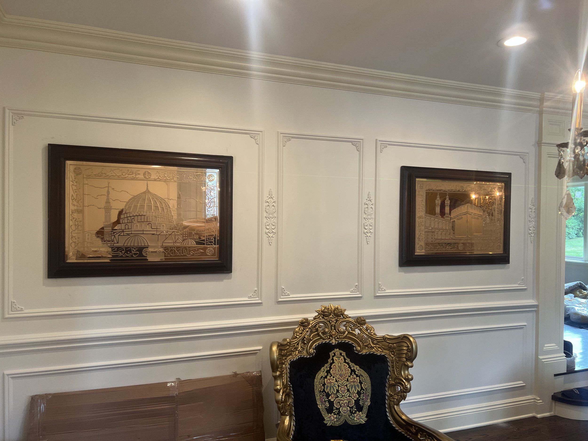 Dining room with white paneled walls and framed artwork