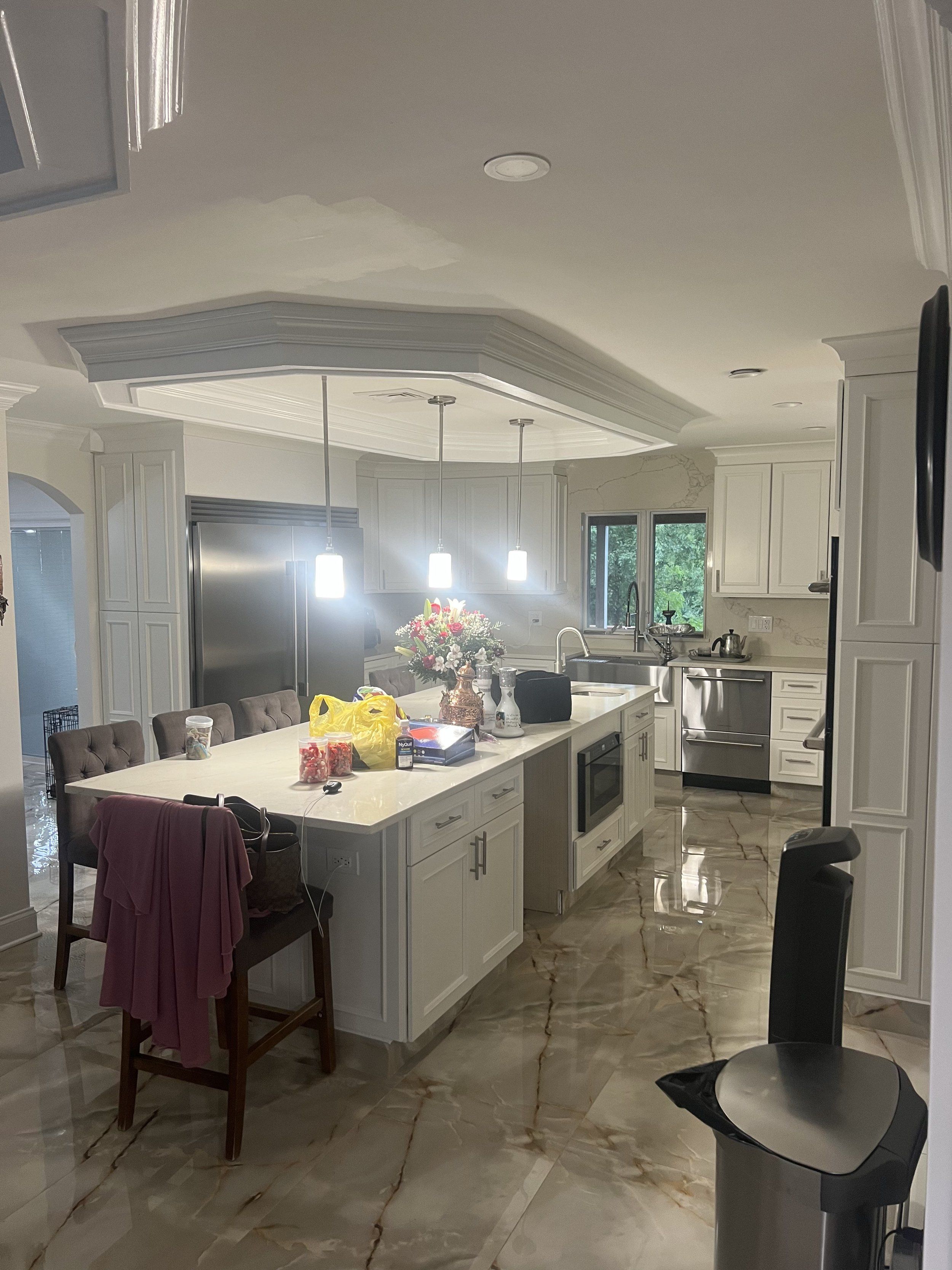 Kitchen with a white island and pendant lights