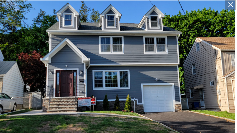 The finished Nutley, NJ home with dormers and white trim