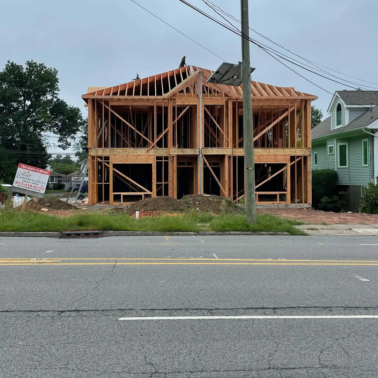 Two-unit townhouse framed from the ground up on a street corner in New Jersey